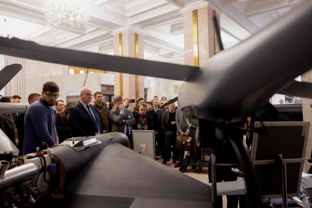 Ukraine's Foreign Minister Andrii Sybiha (2ndL) attends the opening of the updated exhibition of defense solutions to mark Ukrainian Defence Industry Day in Kyiv, on April 13, 2026, amid the Russian invasion of Ukraine. (Photo by Tetiana DZHAFAROVA / AFP)