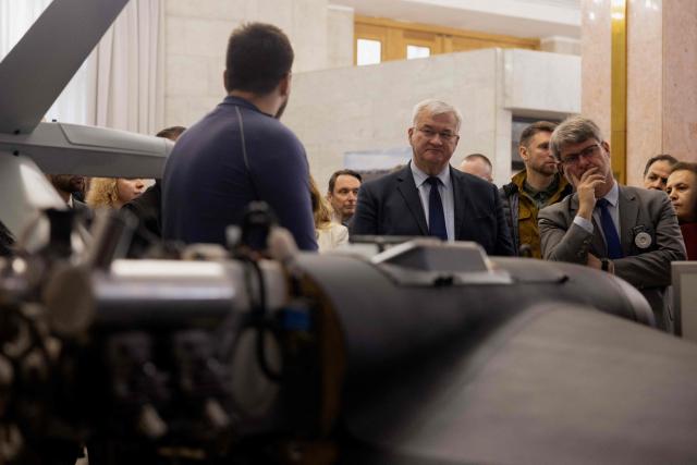 Ukraine's Foreign Minister Andrii Sybiha (C) attends the opening of the updated exhibition of defense solutions to mark Ukrainian Defence Industry Day in Kyiv, on April 13, 2026, amid the Russian invasion of Ukraine. (Photo by Tetiana DZHAFAROVA / AFP)