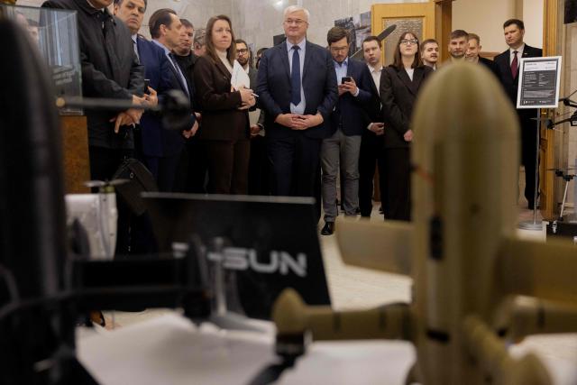Ukraine's Foreign Minister Andrii Sybiha (C) attends the opening of the updated exhibition of defense solutions to mark Ukrainian Defence Industry Day in Kyiv, on April 13, 2026, amid the Russian invasion of Ukraine. (Photo by Tetiana DZHAFAROVA / AFP)