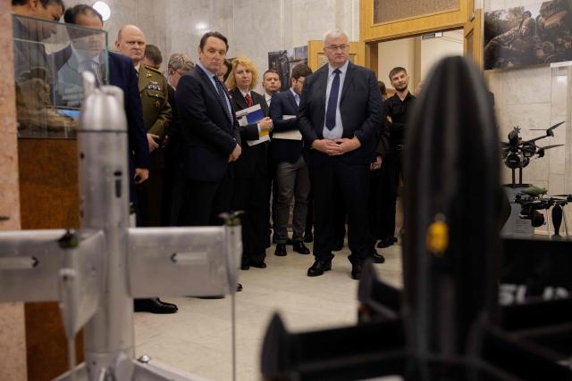 Ukraine's Foreign Minister Andrii Sybiha (C) attends the opening of the updated exhibition of defense solutions to mark Ukrainian Defence Industry Day in Kyiv, on April 13, 2026, amid the Russian invasion of Ukraine. (Photo by Tetiana DZHAFAROVA / AFP)