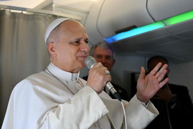 Pope Leo XIV addresses journalists during the flight heading to Algiers on April 13, 2026. Pope Leo XIV embarks today on an 11-day visit to Algeria, Cameroon, Angola and Equatorial Guinea for his first major international trip since becoming pontiff last year. (Photo by Alberto PIZZOLI / POOL / AFP)