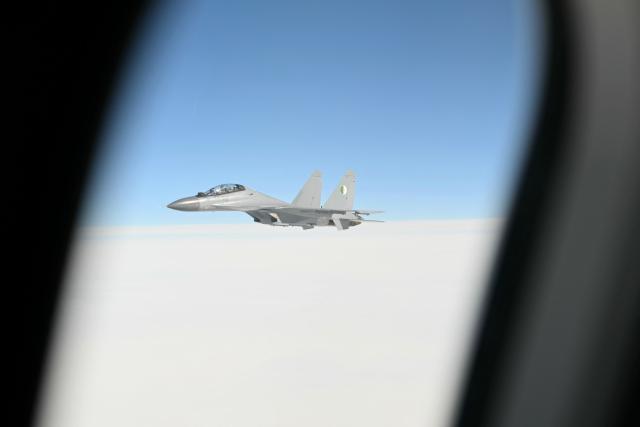 An Algerian fighter jet escorts Pope Leo XIV plane during the flight heading to Algiers on April 13, 2026. Pope Leo XIV embarks today on an 11-day visit to Algeria, Cameroon, Angola and Equatorial Guinea for his first major international trip since becoming pontiff last year. (Photo by Alberto PIZZOLI / POOL / AFP)