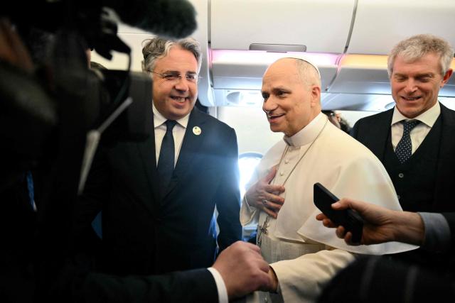 Pope Leo XIV addresses journalists during the flight heading to Algiers on April 13, 2026. Pope Leo XIV embarks today on an 11-day visit to Algeria, Cameroon, Angola and Equatorial Guinea for his first major international trip since becoming pontiff last year. (Photo by Alberto PIZZOLI / POOL / AFP)