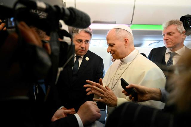 Pope Leo XIV addresses journalists during the flight heading to Algiers on April 13, 2026. Pope Leo XIV embarks today on an 11-day visit to Algeria, Cameroon, Angola and Equatorial Guinea for his first major international trip since becoming pontiff last year. (Photo by Alberto PIZZOLI / POOL / AFP)