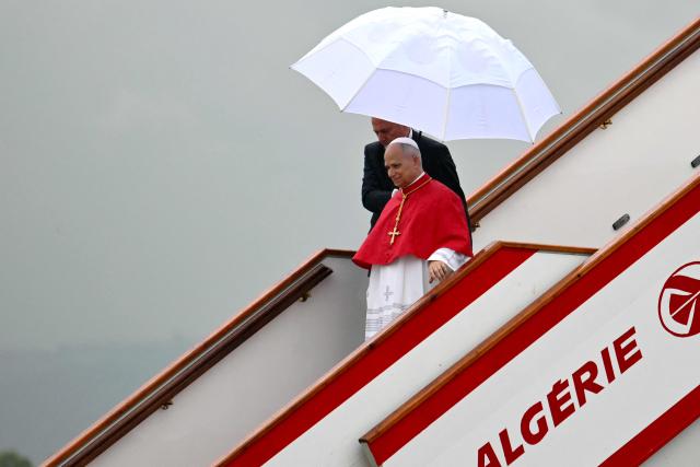 Pope Leo XIV disembarks from the plane after landing at the Houari Boumediene International Airport on April 13, 2026. Pope Leo XIV embarks today on an 11-day visit to Algeria, Cameroon, Angola and Equatorial Guinea for his first major international trip since becoming pontiff last year. (Photo by Alberto PIZZOLI / AFP)