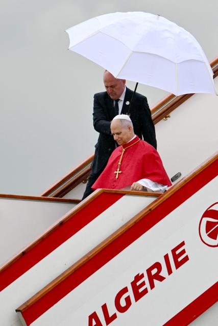 Pope Leo XIV disembarks from the plane after landing at the Houari Boumediene International Airport on April 13, 2026. Pope Leo XIV embarks today on an 11-day visit to Algeria, Cameroon, Angola and Equatorial Guinea for his first major international trip since becoming pontiff last year. (Photo by Alberto PIZZOLI / AFP)