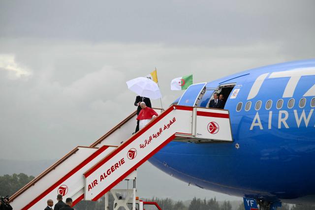 Pope Leo XIV disembarks from the plane after landing at the Houari Boumediene International Airport on April 13, 2026. Pope Leo XIV embarks today on an 11-day visit to Algeria, Cameroon, Angola and Equatorial Guinea for his first major international trip since becoming pontiff last year. (Photo by Alberto PIZZOLI / AFP)