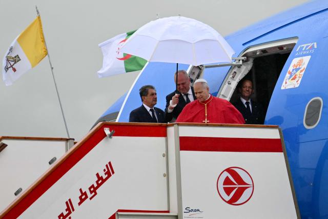 Pope Leo XIV disembarks from the plane after landing at the Houari Boumediene International Airport on April 13, 2026. Pope Leo XIV embarks today on an 11-day visit to Algeria, Cameroon, Angola and Equatorial Guinea for his first major international trip since becoming pontiff last year. (Photo by Alberto PIZZOLI / AFP)
