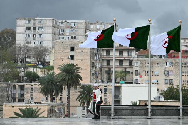 A guard stands before the arrival of Pope Leo XIV for the visit of the Maqam Echahid Martyrs’ Monument in El Madania, near Algiers on April 13, 2026. Pope Leo XIV embarks today on an 11-day visit to Algeria, Cameroon, Angola and Equatorial Guinea for his first major international trip since becoming pontiff last year. (Photo by Alberto PIZZOLI / POOL / AFP)