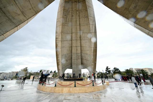 Pope Leo XIV visits the Maqam Echahid Martyrs’ Monument in El Madania, near Algiers on April 13, 2026. Pope Leo XIV embarks today on an 11-day visit to Algeria, Cameroon, Angola and Equatorial Guinea for his first major international trip since becoming pontiff last year. (Photo by Alberto PIZZOLI / POOL / AFP)