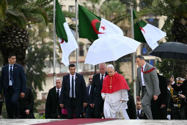 Pope Leo XIV visits the Maqam Echahid Martyrs’ Monument in El Madania, near Algiers on April 13, 2026. Pope Leo XIV embarks today on an 11-day visit to Algeria, Cameroon, Angola and Equatorial Guinea for his first major international trip since becoming pontiff last year. (Photo by Alberto PIZZOLI / POOL / AFP)