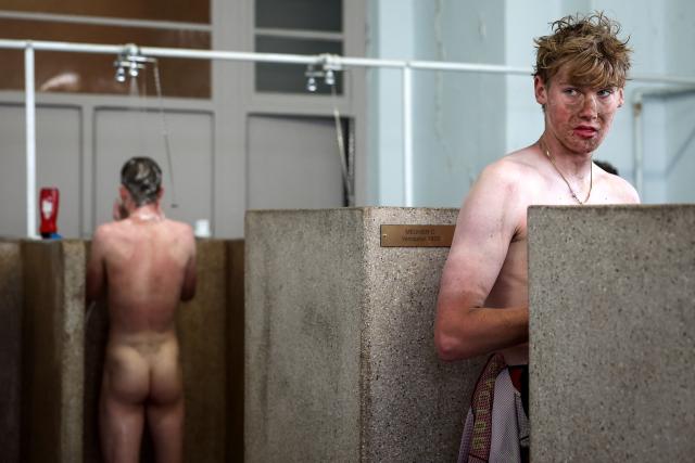 Modern Adventure Pro Cycling's US rider Ezra Caudell takes a shower at the end of the 123rd edition of the Paris-Roubaix one-day classic cycling race, 258.3 km between Compiègne and Roubaix, at the Vélodrome André-Pétrieux in Roubaix, northern France, on April 12, 2026. (Photo by Anne-Christine POUJOULAT / AFP)