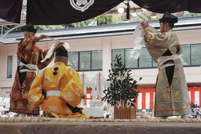 Sumo referees purify the sumo ring before the annual "honozumo", a ceremonial one-day sumo exhibition for spectators held at Yasukuni Shrine in Tokyo on April 13, 2026. (Photo by Kazuhiro NOGI / AFP)