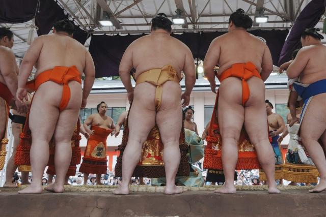 Top ranking sumo wrestlers take part in the annual "honozumo", a ceremonial one-day sumo exhibition for spectators held at Yasukuni Shrine in Tokyo on April 13, 2026. (Photo by Kazuhiro NOGI / AFP)