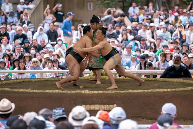 Sumo wrestlers take part in the annual "honozumo", a ceremonial one-day sumo exhibition for spectators held at Yasukuni Shrine in Tokyo on April 13, 2026. (Photo by Kazuhiro NOGI / AFP)