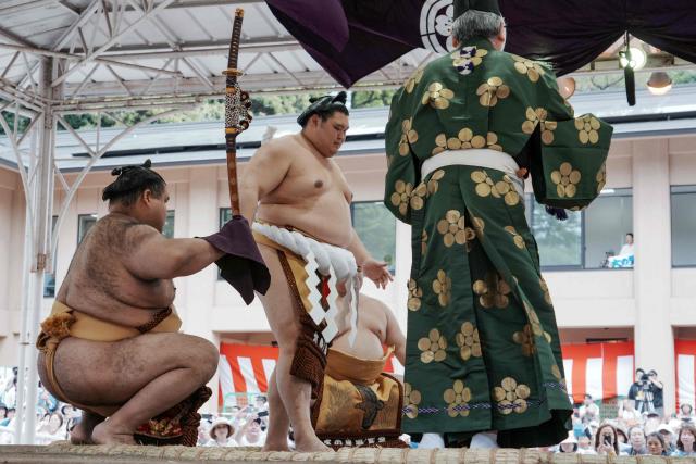 Top ranking sumo wrestlers take part in the annual "honozumo", a ceremonial one-day sumo exhibition for spectators held at Yasukuni Shrine in Tokyo on April 13, 2026. (Photo by Kazuhiro NOGI / AFP)