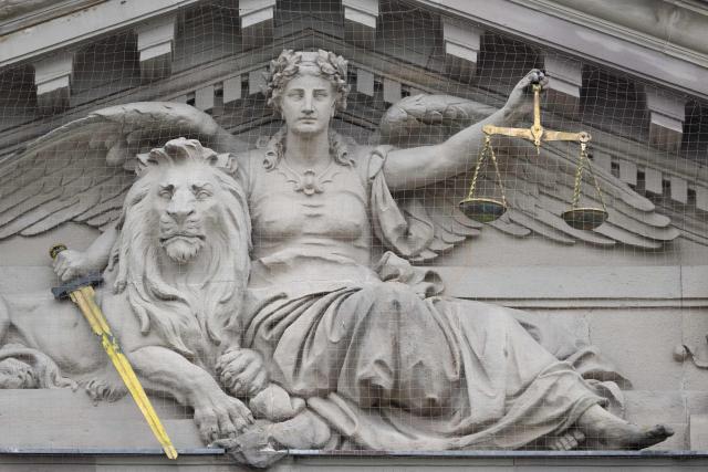 This photograph shows a pedimental sculpture of Lady Justice with a lion on the facade of the Strasbourg courthouse on April 13, 2026. (Photo by SEBASTIEN BOZON / AFP)