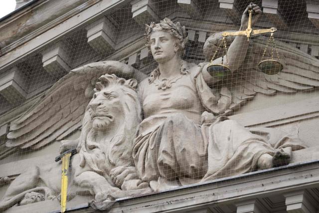 This photograph shows a pedimental sculpture of Lady Justice with a lion on the facade of the Strasbourg courthouse on April 13, 2026. (Photo by SEBASTIEN BOZON / AFP)