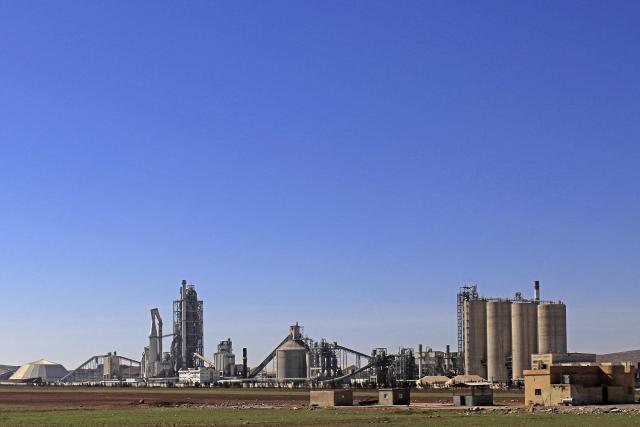 (FILES) A general view shows the Lafarge Cement Syria (LCS) cement plant in Jalabiya, some 30 kms from Ain Issa, in northern Syria, in February 19, 2018. A French court on April 13, 2026 ruled that cement conglomerate Lafarge was guilty of paying the Islamic State group and other jihadists protection money to maintain its business in war-torn Syria. The court found Lafarge, which has since been acquired by Swiss conglomerate Holcim, paid millions of dollars in 2013 and 2014, via its subsidiary Lafarge Cement Syria (LCS), to jihadist groups and intermediaries to keep its plant operating in northern Syria. (Photo by Delil SOULEIMAN / AFP)
