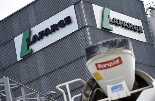 (FILES) A picture shows the logo on a plant of French cement company Lafarge on April 7, 2014 in Paris. A French court on April 13, 2026 ruled that cement conglomerate Lafarge was guilty of paying the Islamic State group and other jihadists protection money to maintain its business in war-torn Syria. The court found Lafarge, which has since been acquired by Swiss conglomerate Holcim, paid millions of dollars in 2013 and 2014, via its subsidiary Lafarge Cement Syria (LCS), to jihadist groups and intermediaries to keep its plant operating in northern Syria. (Photo by FRANCK FIFE / AFP)