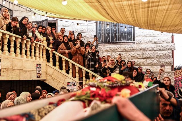 EDITORS NOTE: Graphic content / Relatives of 23-year-old Ali Majed Hamadneh gather during his funeral in the village of Deir Jarir, northeast of the city of Ramallah, in the Israeli-occupied Palestinian West Bank on April 13, 2026. The Palestinian health ministry reported on April 12, 2026, that Israeli settlers shot dead Hamadneh in the occupied West Bank, while the military said a soldier had opened fire during a "violent riot". Violence in the West Bank, which Israel has occupied since 1967, has risen sharply since the October 7, 2023 Hamas attack on Israel triggered the Gaza war. (Photo by Zain JAAFAR / AFP)