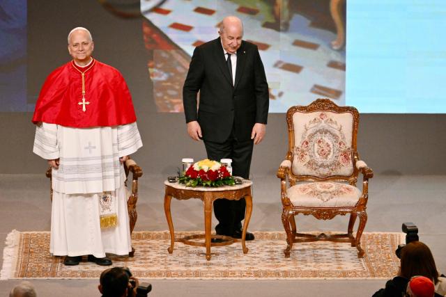 Pope Leo XIV and Algeria's President Abdelmadjid Tebboune attend a meeting with the civil society and the diplomatic corps at the “Djamaa el Djazair” Conference Center on April 13, 2026. Pope Leo XIV embarks today on an 11-day visit to Algeria, Cameroon, Angola and Equatorial Guinea for his first major international trip since becoming pontiff last year. (Photo by Alberto PIZZOLI / AFP)