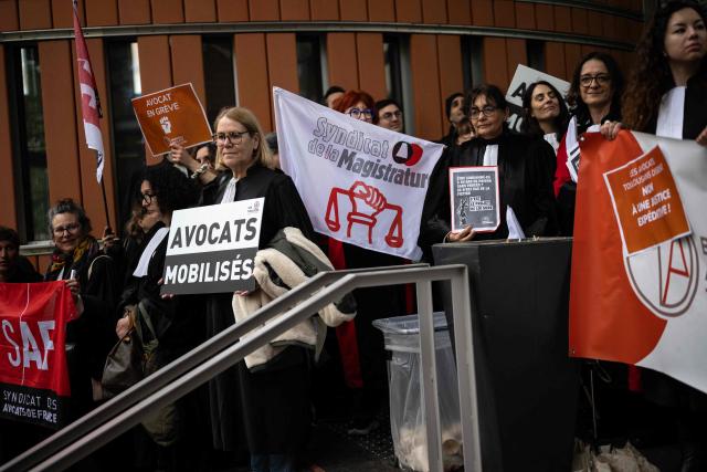 Lawyers gather on the steps of Toulouse's courthouse to protest Justice Minister's draft bill, in particular his proposal to introduce plea bargaining in criminal matters, in Toulouse on April 13, 2026. (Photo by Lionel BONAVENTURE / AFP)