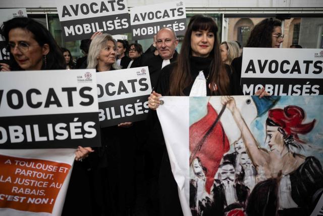 Lawyers gather on the steps of Toulouse's courthouse to protest Justice Minister's draft bill, in particular his proposal to introduce plea bargaining in criminal matters, in Toulouse on April 13, 2026. (Photo by Lionel BONAVENTURE / AFP)