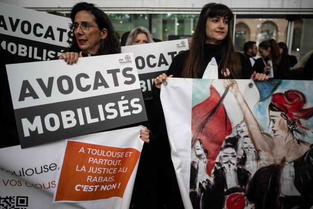 Lawyers gather on the steps of Toulouse's courthouse to protest Justice Minister's draft bill, in particular his proposal to introduce plea bargaining in criminal matters, in Toulouse on April 13, 2026. (Photo by Lionel BONAVENTURE / AFP)