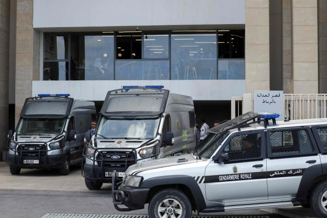 Police vans believed to be transporting Senegalese detainees arrive at the Rabat Court of Appeal on April 13, 2026. A Moroccan court on February 19 sentenced 18 Senegalese football fans to prison terms ranging from three to 12 months over hooliganism charges. The group had been in pre-trial detention since January 18, the day of the heated AFCON final in which Morocco lost to Senegal 1-0 on home turf, after some Senegalese supporters attempted a pitch invasion while others threw objects onto the field. (Photo by Abdel Majid BZIOUAT / AFP)