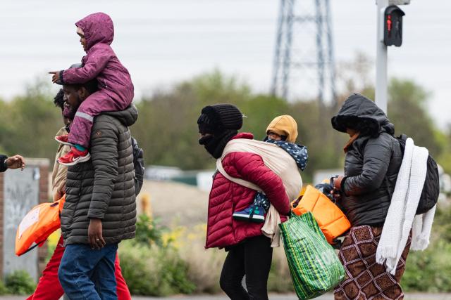 Migrants head to a beach to be smuggled to Britain through the English Channel, in Grande-Synthe, near Dunkirk, northern France on April, 13, 2026. (Photo by Sameer Al-DOUMY / AFP)