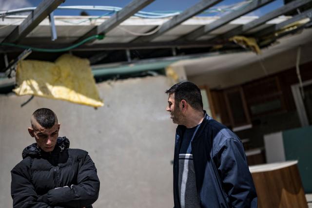 Mahmoud al-Tawil (R) looks on next to his nephew Safwuad al-Tawil in his roofless apartment on the top floor of his family home in the Shayah district of Ras al-Amud in Israeli-annexed east Jerusalem, on April 12, 2026. The rooftop of the al-Tawil family home has been slated for voluntary demolition with an injunction from the Jerusalem Municipality for lack of proper building permits.
Israeli authorities regularly target what they describe as unauthorised construction in Jerusalem's annexed east, a campaign that local Palestinian officials characterise as a "systematic policy" to displace residents. (Photo by MARCO LONGARI / AFP)