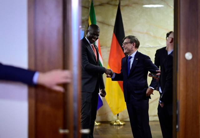 German Foreign Minister Johann Wadephul (R) shakes hands with his South African counterpart Ronald Ozzy Lamola during a visit at the Foreign Office in Berlin on April 13, 2026. (Photo by Tobias SCHWARZ / AFP)