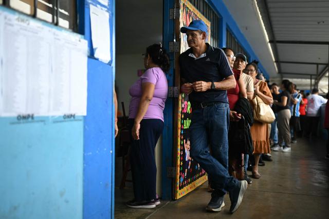 People wait in line at a polling station in Lima on April 13, 2026, after logistical failures prevented tens of thousands of people from voting in presidential and legislative elections the day before. Peru's Keiko Fujimori looked set to face a runoff against a conservative rival after a troubled first-round presidential election on April 12, 2026 marred by logistics foul-ups, police raids and allegations of fraud. (Photo by ERNESTO BENAVIDES / AFP)