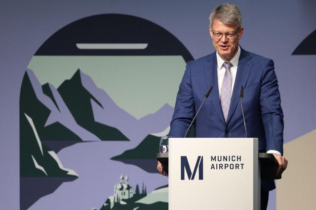 German Transport Minister Patrick Schnieder addresses a press conference on the official opening of the new Terminal 1 pier at Munich International Airport, southern Germany on April 13, 2026. The Terminal 1 Pier provides additional capacity for up to six million passengers per year. The new building is currently one of Bavaria’s largest infrastructure projects. (Photo by Alexandra BEIER / AFP)