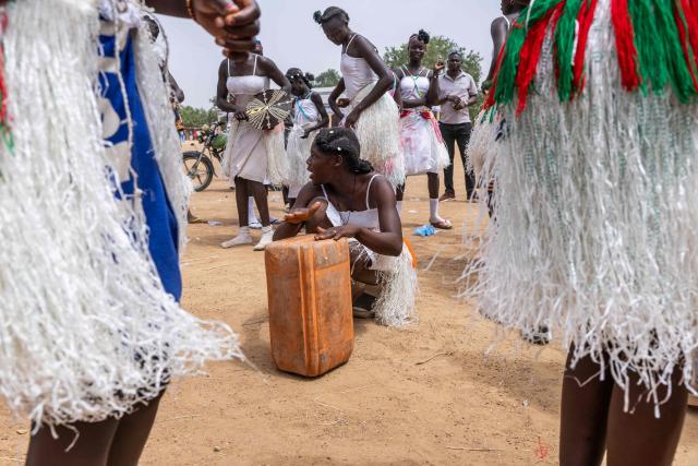 A woman plays a drum on a barrel while a group of Chadian dancers from the Massa people perform a Guruna, a traditional Massa dance, at the Tokna Massana Festival in Bongor on April 9, 2026. The culture of the Massa people was celebrated at the 10th edition of the Tokna Massana festival.
This year's celebration took on a special significance following the inscription last December of Guruna, a Massa pastoral initiation ritual, on UNESCO's list of intangible cultural heritage. (Photo by Joris Bolomey / AFP)