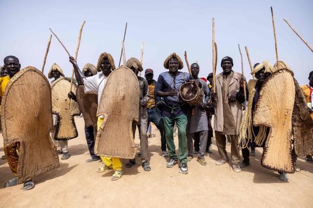 Massa people dressed as fighters arrive at the opening ceremony of the Tokna Massana Festival in Bongor on April 10, 2026. The culture of the Massa people was celebrated at the 10th edition of the Tokna Massana festival.
This year's celebration took on a special significance following the inscription last December of Guruna, a Massa pastoral initiation ritual, on UNESCO's list of intangible cultural heritage. (Photo by Joris Bolomey / AFP)