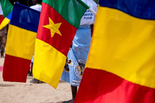 A Cameroonian flag is held between two Chadian flags at the opening ceremony of the Tokna Massana Festival in Bongor on April 10, 2026. The culture of the Massa people was celebrated at the 10th edition of the Tokna Massana festival.
This year's celebration took on a special significance following the inscription last December of Guruna, a Massa pastoral initiation ritual, on UNESCO's list of intangible cultural heritage. (Photo by Joris Bolomey / AFP)