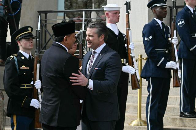 US Defense Secretary Pete Hegseth (R) greets Indonesian Defense Minister Sjafrie Sjamsoeddin during an honor cordon welcoming ceremony for Sjamsoeddin at the Pentagon in Washington, DC, on April 13, 2026. (Photo by Jim WATSON / AFP)