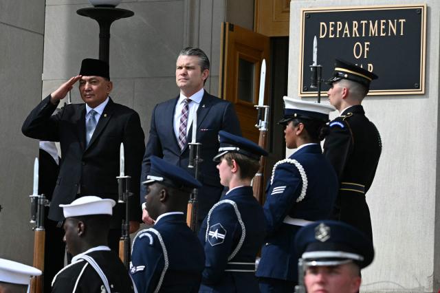 US Defense Secretary Pete Hegseth (R) and Indonesian Defense Minister Sjafrie Sjamsoeddin listen as national anthems are played during an honor cordon welcoming ceremony for Sjamsoeddin at the Pentagon in Washington, DC, on April 13, 2026. (Photo by Jim WATSON / AFP)