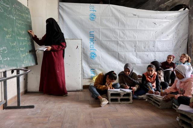 Displaced Palestinian children attend class inside a tent at the Mada Educational School in the Jabalia refugee camp in the northern Gaza Strip on April 13, 2026. Since the terms of a US-brokered ceasefire deal came into effect on October 10, Israel remains in control of nearly half of the Gaza Strip, including all its border areas. Nearly two million people in Gaza are living in makeshift shelters, and the humanitarian situation remains dire, according to aid agencies. (Photo by Omar AL-QATTAA / AFP)