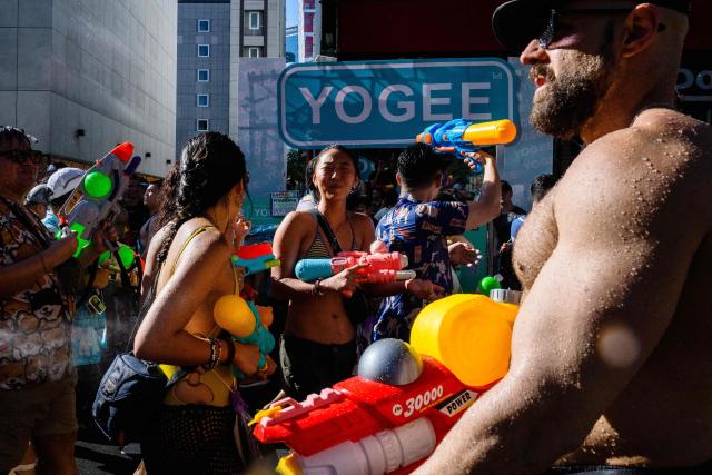 Revellers take part in mass water fights on the first day of Songkran, or Thai New Year, in Bangkok on April 13, 2026. (Photo by Anthony WALLACE / AFP)