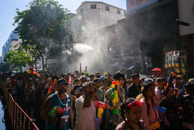 Revellers take part in mass water fights on the first day of Songkran, or Thai New Year, in Bangkok on April 13, 2026. (Photo by Anthony WALLACE / AFP)