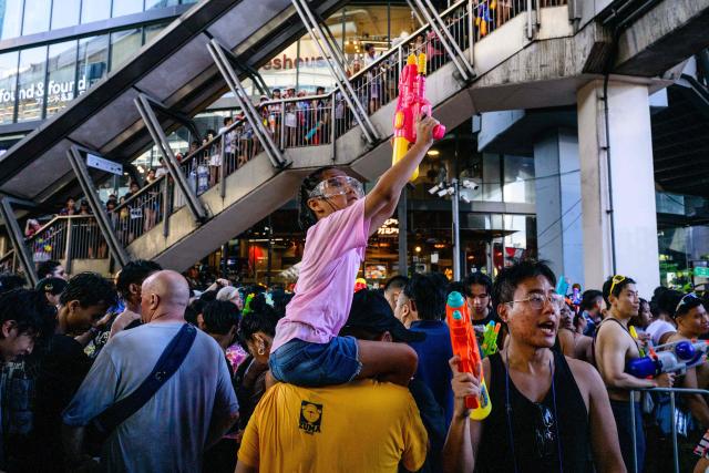 Revellers take part in mass water fights on the first day of Songkran, or Thai New Year, in Bangkok on April 13, 2026. (Photo by Anthony WALLACE / AFP)
