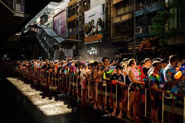 Revellers take part in mass water fights on the first day of Songkran, or Thai New Year, in Bangkok on April 13, 2026. (Photo by Anthony WALLACE / AFP)