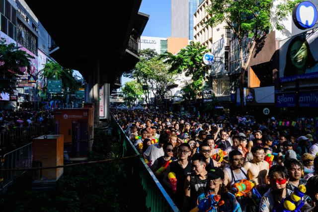 Revellers take part in mass water fights on the first day of Songkran, or Thai New Year, in Bangkok on April 13, 2026. (Photo by Anthony WALLACE / AFP)