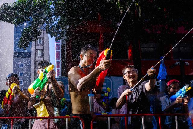 Revellers take part in mass water fights on the first day of Songkran, or Thai New Year, in Bangkok on April 13, 2026. (Photo by Anthony WALLACE / AFP)