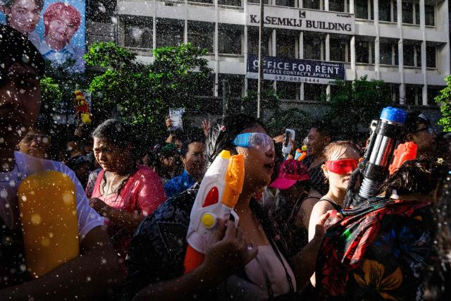 Revellers take part in mass water fights on the first day of Songkran, or Thai New Year, in Bangkok on April 13, 2026. (Photo by Anthony WALLACE / AFP)