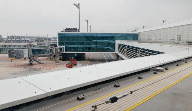 This general overview taken on April 13, 2026 shows an outside view of the new Terminal 1 pier at the Munich International Airport in Munich, southern Germany. The Terminal 1 Pier provides additional capacity for up to six million passengers per year. The new building is currently one of Bavaria’s largest infrastructure projects. (Photo by ALEXANDRA BEIER / AFP)