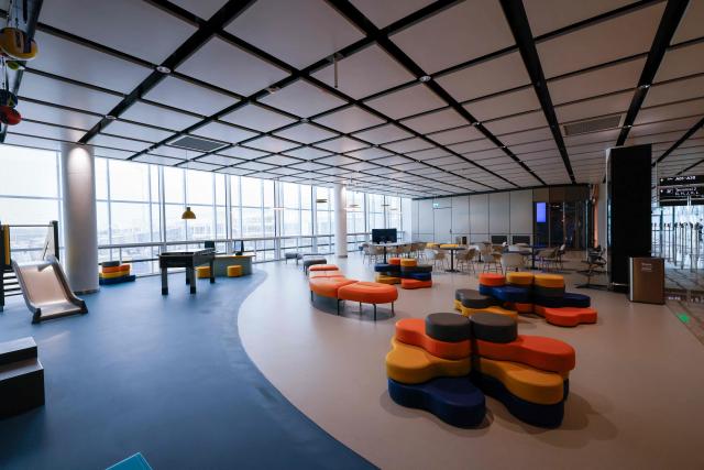 This photo taken on April 13, 2026 shows a waiting area for passengers at the gates of the new Terminal 1 pier at Munich International Airport during the official opening in Munich, southern Germany. The Terminal 1 Pier, which will begin operations on April 21, 2026, provides additional capacity for up to six million passengers per year. The new building is currently one of Bavaria’s largest infrastructure projects. (Photo by ALEXANDRA BEIER / AFP)